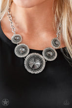 Load image into Gallery viewer, Gradually increasing in size, dramatically oversized smoky gems are pressed into the centers of hammered and silver studded frames. The blinding frames link below the collar for a glamorous, statement-making finish. Features an adjustable clasp closure.  Sold as one individual necklace. Includes one pair of matching earrings.